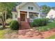 Inviting front porch with brick steps and lush landscaping, creating a warm welcome at 116 Wright Hill Dr, Durham, NC 27712