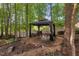 Outdoor gazebo featuring wood decking, seating, and a fire pit for relaxing in the backyard at 116 Wright Hill Dr, Durham, NC 27712