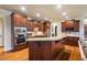 Gourmet kitchen with custom wood cabinets, granite countertops, and stainless steel appliances at 116 Wright Hill Dr, Durham, NC 27712