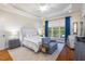 Comfortable main bedroom featuring large window with seating area and decorative rug at 116 Wright Hill Dr, Durham, NC 27712