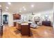 Open floor plan with kitchen island, living room fireplace, and elegant hardwood floors at 116 Wright Hill Dr, Durham, NC 27712