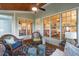 Cozy screened-in porch with wicker furniture and ceiling fan, perfect for relaxing at 116 Wright Hill Dr, Durham, NC 27712