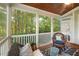 Relaxing screened porch featuring wicker furniture, wood ceiling, and wooded views at 116 Wright Hill Dr, Durham, NC 27712