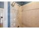 Shower with decorative tilework, and nickel fixtures, complimented by blue paint at 116 Wright Hill Dr, Durham, NC 27712