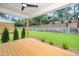 Spacious backyard featuring a well-maintained lawn, landscaping, stone retaining wall, and access from the covered porch at 1211 Chaney Rd, Raleigh, NC 27606