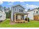 New backyard with a wood deck, grass, and a view of the home's exterior at 1211 Chaney Rd, Raleigh, NC 27606