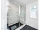 Bathroom showcasing a glass shower with built-in bench and marble-style tile surround at 1211 Chaney Rd, Raleigh, NC 27606