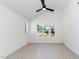 Spacious bedroom with vaulted ceilings, a fan, a large window and white walls at 1211 Chaney Rd, Raleigh, NC 27606