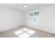 Bright bedroom with neutral carpet, white walls, window and door at 1211 Chaney Rd, Raleigh, NC 27606