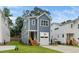 Charming two-story home with a blue exterior, white trim, front-facing garage and a well-manicured lawn at 1211 Chaney Rd, Raleigh, NC 27606
