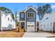 Charming two-story home with a garage and a wooden staircase leading to the front entrance at 1211 Chaney Rd, Raleigh, NC 27606