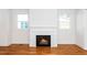 A cozy fireplace nestled between two windows in a well lit room at 1211 Chaney Rd, Raleigh, NC 27606