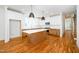 Spacious kitchen with large island, stainless steel appliances, and hardwood flooring at 1211 Chaney Rd, Raleigh, NC 27606