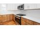 Modern kitchen featuring stainless steel appliances, granite countertops, and white cabinetry at 1211 Chaney Rd, Raleigh, NC 27606