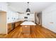 Spacious kitchen with large island, stainless steel appliances, and hardwood flooring at 1211 Chaney Rd, Raleigh, NC 27606