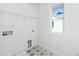 Laundry room with geometric tile flooring, utility sink and storage shelves at 1211 Chaney Rd, Raleigh, NC 27606