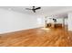 An open-concept living room with fireplace, hardwood floors and view into the kitchen at 1211 Chaney Rd, Raleigh, NC 27606