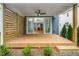 Covered porch featuring modern horizontal fence, a ceiling fan, wooden floor, and sliding door to living room at 1211 Chaney Rd, Raleigh, NC 27606