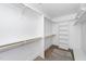 Walk-in closet with ample shelving, wooden hanging rods and carpet flooring at 1211 Chaney Rd, Raleigh, NC 27606