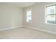 Inviting bedroom with carpet and natural light from two windows, enhancing the cozy atmosphere at 1245 Barreto Dr, Wendell, NC 27591