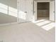 Bright bedroom featuring plush carpeting, neutral walls, and a closet with double doors, creating a serene and inviting space at 1245 Barreto Dr, Wendell, NC 27591