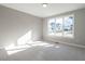 Neutral bedroom featuring a large window overlooking neighborhood with carpet and neutral walls at 1245 Barreto Dr, Wendell, NC 27591