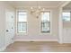 Bright dining area with hardwood floors, a modern chandelier, and built-in cabinets at 1245 Barreto Dr, Wendell, NC 27591