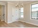 Elegant dining area featuring hardwood floors, a modern chandelier, and natural light at 1245 Barreto Dr, Wendell, NC 27591