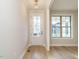 Bright foyer features hardwood floors, white trim, and a stylish pendant light fixture at 1245 Barreto Dr, Wendell, NC 27591