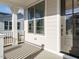 Inviting front porch with stylish gray front door, classic white columns and painted gray siding at 1245 Barreto Dr, Wendell, NC 27591