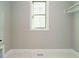 Neutral laundry room with marble floors, window, and closet space; ideal for modern convenience at 1245 Barreto Dr, Wendell, NC 27591