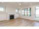 Bright living room with a fireplace, built-in cabinets, and a view of the porch at 1245 Barreto Dr, Wendell, NC 27591
