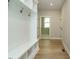Mudroom with bench, hooks, and storage compartments for an organized entryway at 1245 Barreto Dr, Wendell, NC 27591