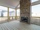 The screened porch features a stone fireplace and wood floors, perfect for enjoying the outdoors in comfort and style at 1245 Barreto Dr, Wendell, NC 27591