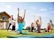 Outdoor yoga area with residents enjoying an exercise class on a grassy lawn in front of a gazebo at 1245 Barreto Dr, Wendell, NC 27591