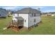 Home's backyard with a screened porch, wood deck, and well-maintained lawn at 1318 Reading Ct, Burlington, NC 27217