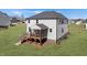 Back of a two-story home featuring a screened porch and stairs to the yard at 1318 Reading Ct, Burlington, NC 27217