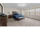 Well-lit bedroom with a rustic wood-paneled headboard and stylish blue bedding at 1318 Reading Ct, Burlington, NC 27217