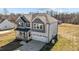 Two-story home with gray and white siding and a covered front porch and two car garage at 1318 Reading Ct, Burlington, NC 27217