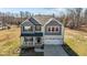 Two-story home with gray and white siding, inviting front porch, and well-manicured lawn at 1318 Reading Ct, Burlington, NC 27217