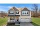 Charming two-story home with a welcoming front porch and a two-car garage at 1318 Reading Ct, Burlington, NC 27217