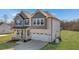 Home with front porch, an attached garage, and a well-maintained lawn at 1318 Reading Ct, Burlington, NC 27217