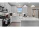Bright kitchen with white cabinets, quartz countertops, and stainless steel appliances at 1318 Reading Ct, Burlington, NC 27217