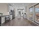 Open kitchen with stainless steel appliances and hardwood flooring, flowing into an area with outdoor access at 1318 Reading Ct, Burlington, NC 27217