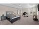 Spacious main bedroom with carpeted floors, complemented by a dedicated workspace and exercise area at 1318 Reading Ct, Burlington, NC 27217