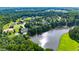 Aerial view of the property, showcasing the house, pond and surrounding neighborhood at 1416 Barony Lake Way, Raleigh, NC 27614