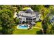 Aerial view of luxury estate showcasing the pool, outdoor kitchen, screened porch, and lush grounds at 1416 Barony Lake Way, Raleigh, NC 27614