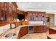 Entertainment bar includes custom wood cabinets, wine fridge, and granite countertops at 1416 Barony Lake Way, Raleigh, NC 27614