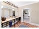 Well-lit bathroom featuring double sinks, a large mirror, and elegant fixtures, offering a practical and stylish design at 1416 Barony Lake Way, Raleigh, NC 27614