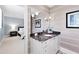Stylish bathroom vanity with a decorative mirror, elegant lighting, and a glimpse into an adjacent bedroom at 1416 Barony Lake Way, Raleigh, NC 27614
